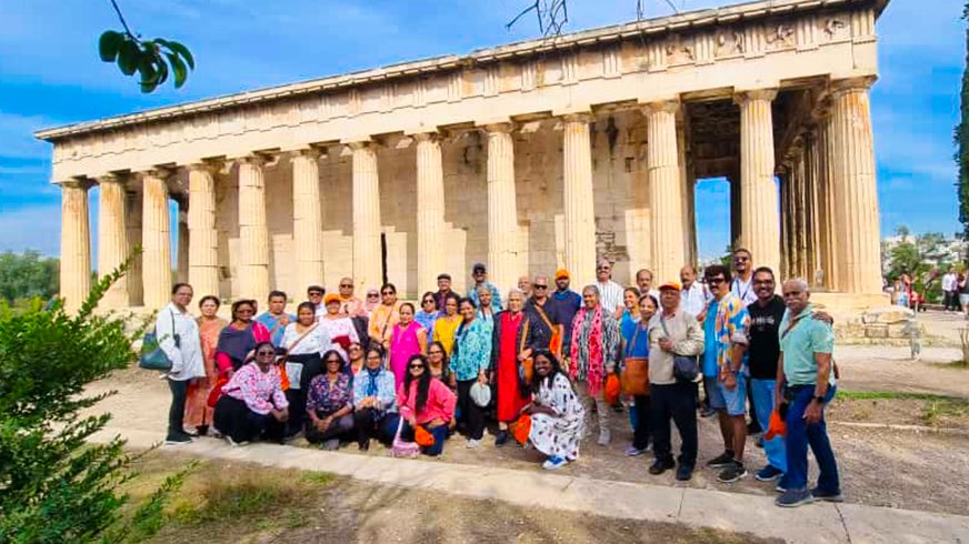 Tourists posing together during an international trip, inspired by the Best Travel & Tourism Expo in Kerala